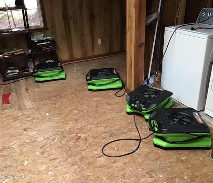 Laundry room with SERVPRO drying equipment on exposed subfloor