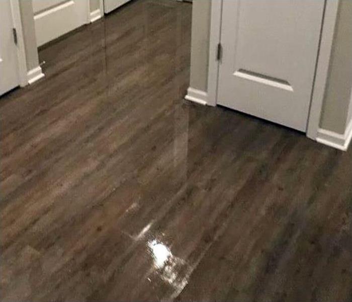 water covering wood flooring after a storm