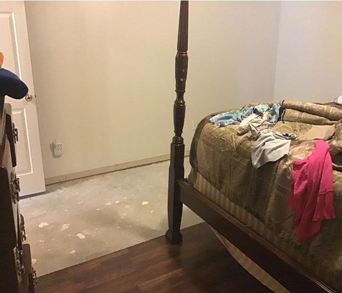 Water damaged flooring in bedroom