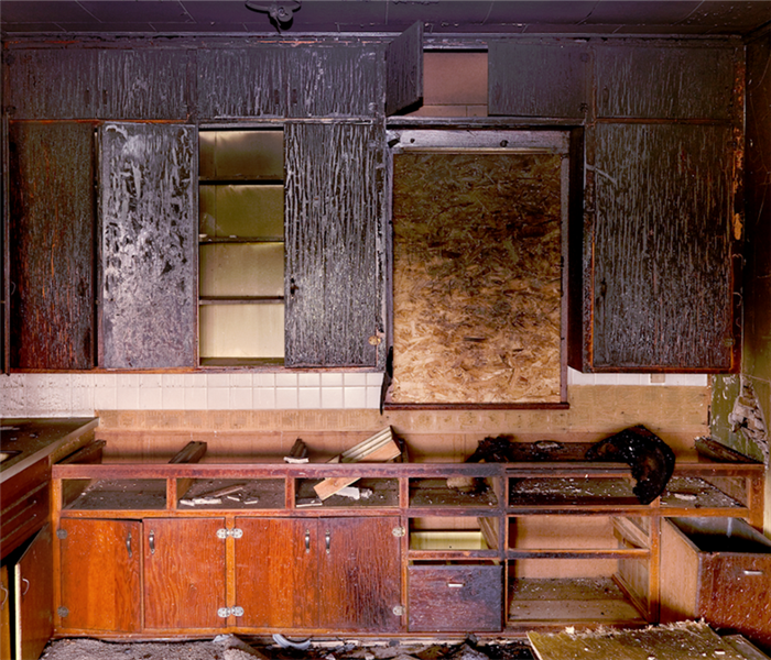 a fire damaged kitchen with soot covering everything