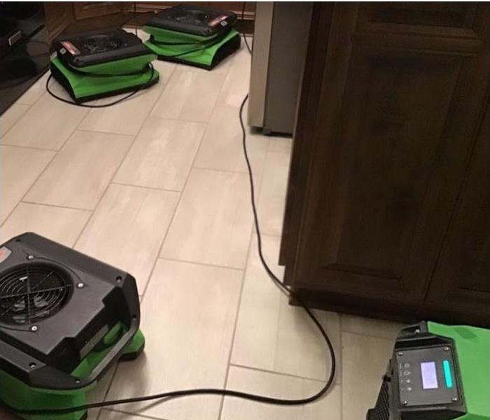 SERVPRO restoration equipment being used on water damaged kitchen floor