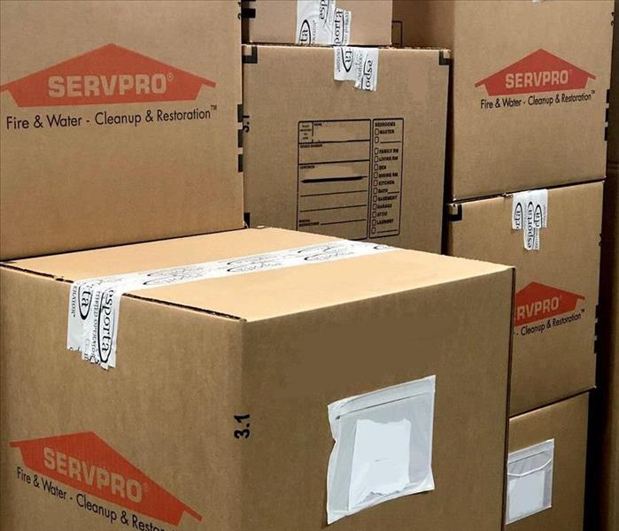 stack of brown boxes with orange SERVPRO logo on the side and Esporta tape as closure to the boxes
